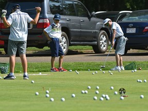 Golf balls litter the green as practice makes prefect for these junior golfers during a clinic on the practice green at the Victoria Golf Club in Edmonton, July 29, 2018. Ed Kaiser/Postmedia