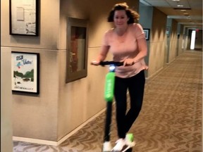 Edmonton Coun. Sarah Hamilton tries out an electric scooter from Lime in the councillor hallway at City Hall. The company is talking about bringing its product to the streets of Edmonton early this fall.  Screencapture image