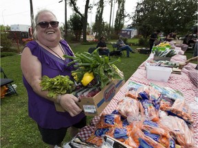 Carrie Ganie volunteers and buys her own food at Food4Good, which just secured a physical storefront to launch its first alternative grocery store in west Edmonton. Ganie gathers produce from a pop-up market at Butler Memorial Park, 15715 Stony Plain Rd. on Thursday, July 26, 2018.