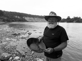 Robin Rosborough, a gold panner with the Alberta Gold Prospectors Association and competitor at the World Gold Panning Association Championship, pans for gold in the North Saskatchewan River near Devon, Alta., on Saturday, June 9, 2018.