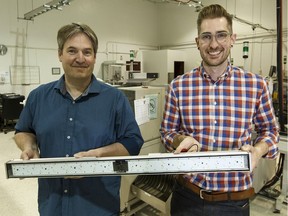 G2V's Michael Taschuk, left, the founder and technical lead, and Ryan Tucker, operations and strategy lead, hold the company's six spectrum light bar in Edmonton, on Tuesday, July 10, 2018. Using research from the University of Alberta, the researchers have created a controllable LED light bar that can imitate the sun, which is useful for hydroponic agriculture and cannabis growing.