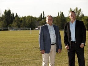 Ernie Kimak (left), president of the Whitemud Creek Homeowners Assocation, and community member Rob McDonald pose for a photo at the Ogilvie Ridge surplus school site. Coun. Tim Cartmell wants local seniors to have the first chance to buy market homes in the development and also to move it from a location where there's a soccer field to an area where there is an under-used, undersized baseball diamond.