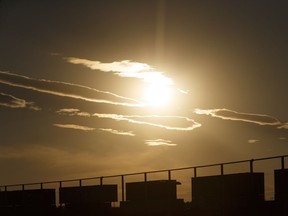 The sun sets behind the CN train yard north of the Yellowhead Highway in Edmonton, on Thursday, July 12, 2018.