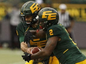 Edmonton Eskimos' quarterback Mike Reilly (13) fakes a handoff to C.J. Gable (2) versus the Toronto Argonauts during a CFL football game at Commonwealth Stadium in Edmonton, on Friday, July 13, 2018. Photo by Ian Kucerak/Postmedia Photos for copy in Saturday, July 14 edition.