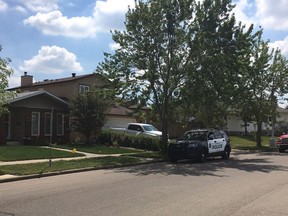 Edmonton police cars park outside a home in Blue Quill on Friday, July 13, 2018, after two people were found dead inside.