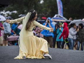 Dancers continued performing in the rain at the Iran pavilion. during Edmonton's Heritage Festival at Hawrelak Park in 2017.
