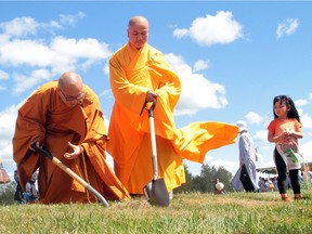 Ven. Thien Tam and Ven. Phap Hoa break ground on a future mausoleum base of the 21.2 metre Amitaba Buddha statue, due to be unveiled this spring at Westlock Meditation Centre.
