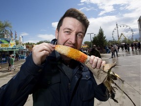 Reporter Stephen Cook tries the Mexican Street Style Corn by Zdebiak Concessions at K-Days on Sunday, July 22, 2018 in Edmonton.