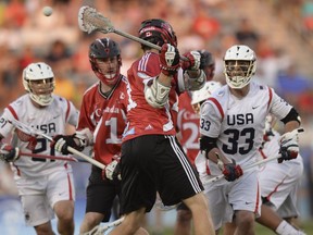 Canada midfielder Kevin Crowley (21) shoots behind his back to score in first half FIL World Lacrosse Championship action against the United States, in Commerce City, Colo., Saturday, July 19, 2014.