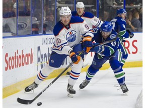 PENTICTON,BC:SEPTEMBER 11, 2017 -- Vancouver Canucks Jonah Gadjovich (right) tries to check Edmonton Oilers Ryan Mantha off the puck during NHL preseason hockey action at the Young Stars Classic held at the South Okanagan Events Centre in Penticton, BC, September, 11, 2017. (Richard Lam/PNG) (For ) 00050537A