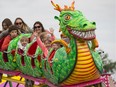 Families ride the roller coaster during Monday Morning Magic at K-Days on July 23, 2018.