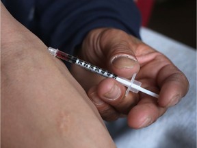A man injecting heroin.