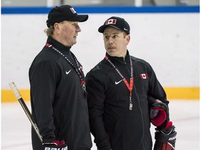 Head Coach Ken Babey, left, and assistant coach Luke Pierce talk as Canada's sledge hockey team practices ahead of the start of competition at the Gangneung practice venue during the 2018 Winter Paralympic Games in Pyeongchang, South Korea, on March 8, 2018.