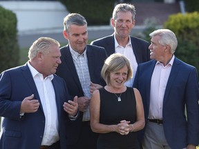 Ontario Premier Doug Ford, left, Nova Scotia Premier Stephen McNeil, Alberta Premier Rachel Notley, Manitoba Premier Brian Pallister and Newfoundland and Labrador Premier Dwight Ball chat as they wait for the official photo at a meeting of Canadian premiers in St. Andrews, N.B., on Wednesday, July 18, 2018.