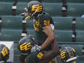 Edmonton Eskimos Jordan Robinson (22) and Travis Bond (58) celebrate a touchdown against the Toronto Argonauts during first half CFL action in Edmonton on Friday July 13, 2018.