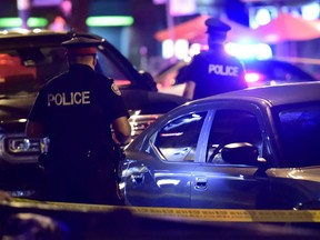 Police work at the scene of a mass casualty incident in Toronto on Sunday, July 22, 2018.