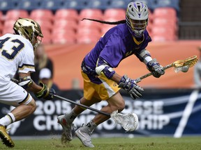 In this May 16, 2015 file photo, Lyle Thompson (right) controls the ball during his days playing for Albany in the NCAA. Thompson is now a star at the professional level and a leading member of the Iroquois Nationals.