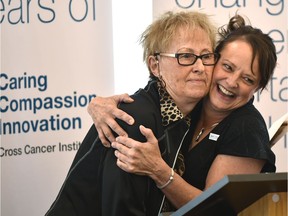 Delores Gerke, left,  gets a hug from Paula Germann, site director, for 55 years of service during a public celebration of the Cross Cancer Institute's 50th anniversary where a recently unearthed 25-year-old time capsule was unveiled in Edmonton on Friday, July 6, 2018.