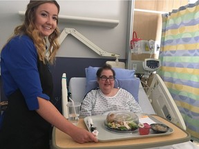 Food ambassador Alana Haggerty (left) gives patient Lanette Lindgren her lunch.