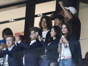 Singer Mick Jagger of the Rolling Stones, in black baseball hat, smiles during the semifinal match between Croatia and England at the 2018 soccer World Cup in the Luzhniki Stadium in, Moscow, Russia, Wednesday, July 11, 2018.