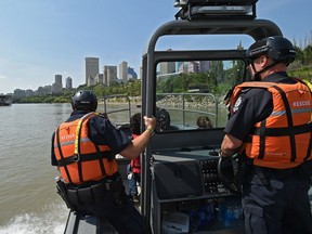 Const.  Jeff Eichmann, left, and Const. Derek Jones are part of the Edmonton Police Service new marine unit which patrol some of the 48 km of the North Saskatchewan River by jet boat and Sea-Doos in Edmonton on Sunday, Aug. 5, 2018.