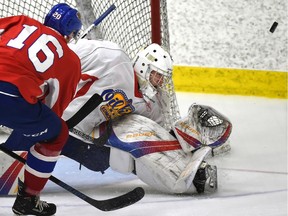 Edmonton Oil Kings David Kope (16) shoots the puck wide on goalie Todd Scott (1) in the annual Red and White intrasquad game during training camp at the Downtown Community Arena in Edmonton, Aug. 29, 2018.