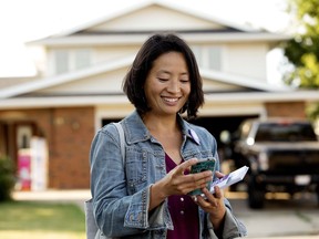 Ward 11 City Council candidate Keren Tang uses the FieldEdge app while campaigning near 69 Street and 21 Avenue, in Edmonton Tuesday July 18, 2017. Tang uses the app to keep track of the homes she has visited, voter contact, as well as being a greener alternative to the paper files used to in the past. Photo by David Bloom