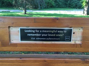 A City of Edmonton advertisement on a bench in Queen Elizabeth Park after a memorial plaque was removed by the city in Aug. 2018.
