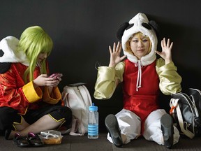 Amy Bagnall (left) and Kim Dela Merced (right) take a break at Animethon 25, held at the Shaw Conference Centre on August 10, 2018. Canada's longest-running anime convention, which started in 1994, continues all weekend. (PHOTO BY LARRY WONG/POSTMEDIA)