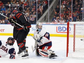 Canada's Kirby Dach (17) looks back as the game-tying goal floats past the United States goaltender Dustin Wolf (30) during third period Hlinka Gretzky Cup semifinal action in Edmonton on Friday, August 10, 2018.