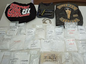 A joint investigation between ALERT and the RCMP has dismantled an extensive cocaine distribution network linked to a member of the Hells Angels and support club members. The seized contraband was displayed by law enforcement in Edmonton on Thursday, Aug. 30, 2018.