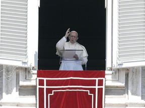 Pope Francis delivers a blessing during the Angelus noon prayer in St. Peter's Square, at the Vatican, Sunday, Aug. 19, 2018.