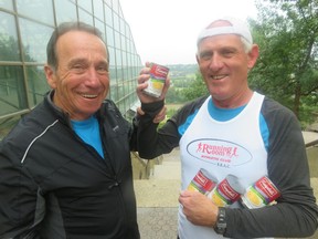 Race organizer John Stanton, left, with Ken Davison, 73, who runs his 100th marathon Aug. 19 in Edmonton.  Davison has his supply of his supply of Campbell's pea soup after his doctor advised him to eat of  the soup to avoid running out of energy near the end of a marathon. It worked.