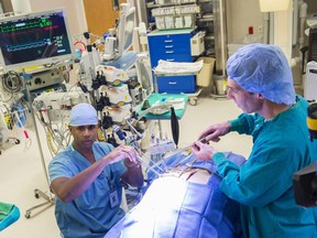 Dr. Jeevan Nagendran, a cardiac surgeon at the Mazankowski in an operating room talking about  a minimally invasive heart surgery program, enabling cardiac surgeons to avoid opening the chest when performing major, open-heart surgery on hundreds of patients in Edmonton each year on October 12, 2017.  Beside him is Registered Nurse Darren Melby.