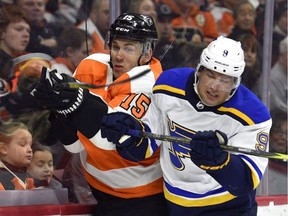 St. Louis Blues' Scottie Upshall, right, checks Philadelphia Flyers' Jori Lehtera into the boards during NHL action in Philadelphia on Jan. 6, 2018.