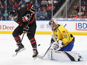 Canada's Sasha Mutala (14) tries to redirect a shot against Sweden's goaltender Jesper Wallstedt (30) during first period Hlinka Gretzky Cup action in Edmonton on Aug. 8, 2018.