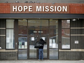 A man peers inside the Hope Mission in downtown Edmonton on March 13, 2017.