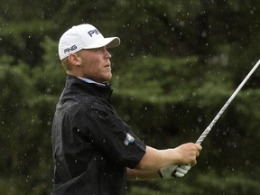 Ian Holt watches his tee shot through the rain on the 10th hole during the third round of the Syncrude Oil Country Championships at the Edmonton Petroleum Golf Club, in Edmonton Saturday Aug. 4, 2018.