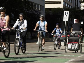 Cyclists take a tour of protected bike lanes during the Cycle in the City Bike Party in Edmonton on Aug. 26, 2017. The party was held to celebrate the opening of the downtown bike network.