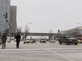 Pedestrians and drivers cross the intersection of 109 Street and 104 Avenue, a location for part of the west LRT line, in Edmonton, Alberta on Friday, Feb. 2, 2018.