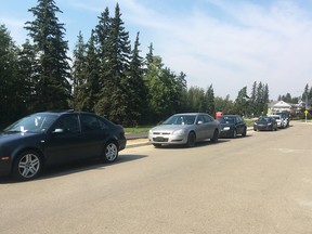 Rows of vehicles were slapped with parking tickets, and some were towed, Monday in the Windsor Park neighbourhood near Heritage Fest at Hawrelak Park.  Nicole Bergot/Postmedia