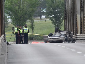 Police investigate a fatal rollover collision in the northbound lane of the Low Level Bridge on Wednesday, Aug. 29, 2018.