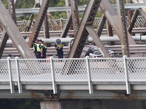 Police investigate a fatal rollover collision in the northbound lane on the Low Level Bridge on Wednesday, Aug. 29, 2018.