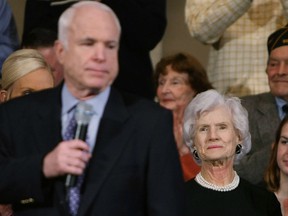 Republican presidential candidate and Senator John McCain (R-AZ) speaks as his mother Roberta, 95, looks on during a campaign appearance at Faneuil Hall February 4, 2008 in Boston, Massachusetts. Roberta, who lives in Washington, spent years crisscrossing the globe, often alongside her identical twin sister, Rowena, eager for whatever spontaneous adventure came next.