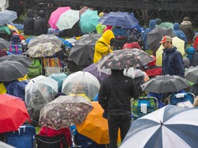 Rain and mud were constant battles for music lovers at the Edmonton Folk Music Festival at Gallagher Park on Sunday, Aug. 12, 2018.