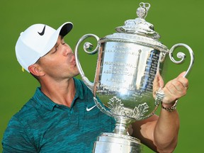 Brooks Koepka kisses the Wanamaker Trophy on the 18th green after winning the PGA Championship on Aug. 12.