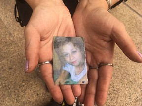 Nevaeh Michaud's mother Desiree Knoll holds a photograph of her daughter who died in a group home in 2014. A fatality inquiry into the child's death as a result of toxicity caused by a sleep aid resumed in Edmonton provincial court on Wednesday, Aug. 22, 2018.