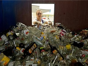 Leah Seabrook (Manager, Waste Management and Community Energy Services Utilities, Strathcona County) places glass products in a recycling bin at the Broadview Enviroservice Station in Sherwood Park on August 22, 2018. Strathcona County will be changing its recycling pick-up program next month and most plastics, glass and styrofoam will no longer be recyclable.