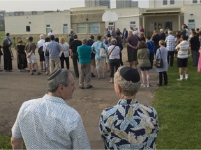 About 100 people gathered on the basketball court behind Torah Talmud school on Aug. 7, 2018, after anti-Semitic graffiti was sprayed in various parts of west Edmonton including the tarmac where kids play at the school on the previous weekend.