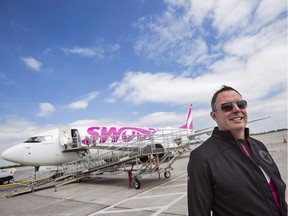 Steven Greenway, President and CEO of Swoop Airlines, poses for a photo in front of one of their Boeing 737 planes on display during a media event, Tuesday, June 19, 2018 at John C. Munro International Airport in Hamilton, Ontario.